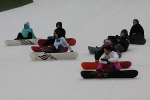 Snowboarders Sitting